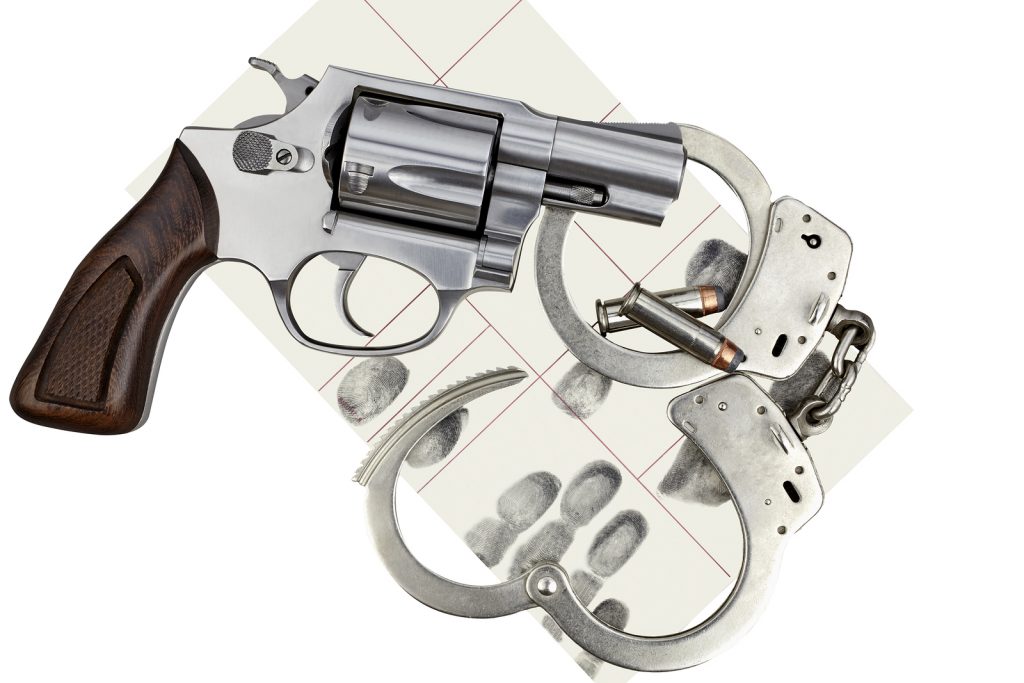 bigstock Gun With Handcuffs And Fingerp 94532111 1 1024x683 - South Jersey Weapons Crimes Defense Lawyer